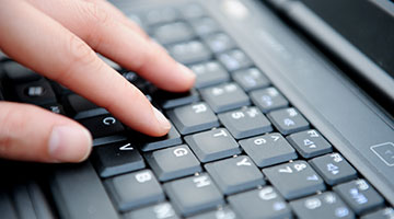 A person typing on a keyboard