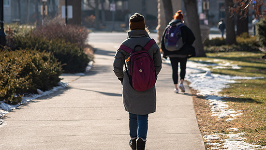 students walking towards arch